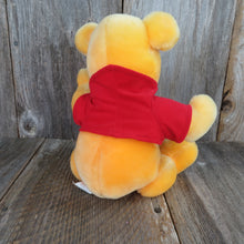 Load image into Gallery viewer, Vintage Winnie the Pooh Plush Musical Jointed Stuffed Animal Disney Store Yellow Red Shirt - At Grandma&#39;s Table