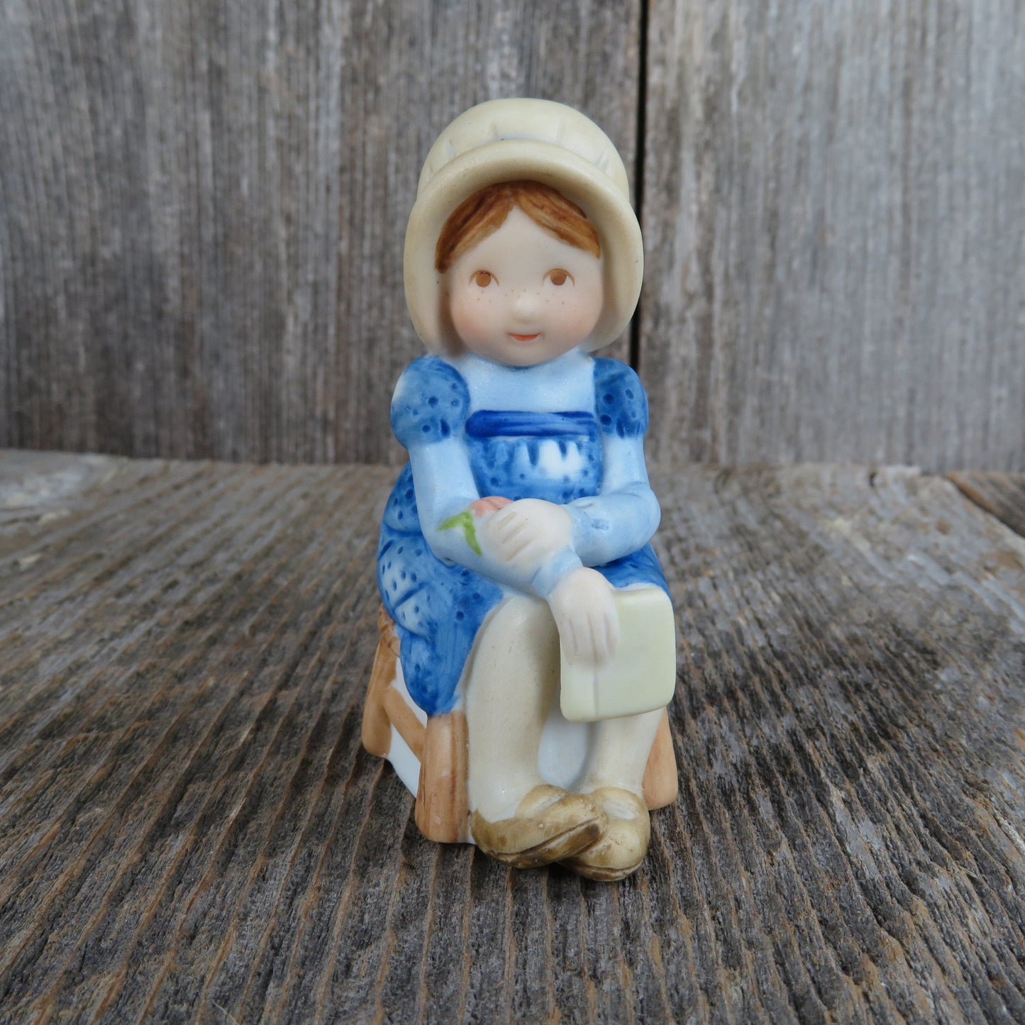 Vintage Holly Hobbie In Blue Dress Figurine Sitting on a Stool Wearing a Bonnet Book Bisque Ceramic